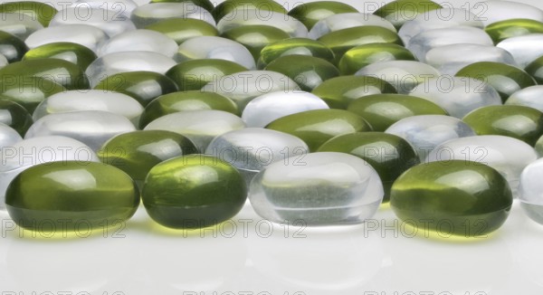 Artificial round stones of green and white color. imitation pebbles