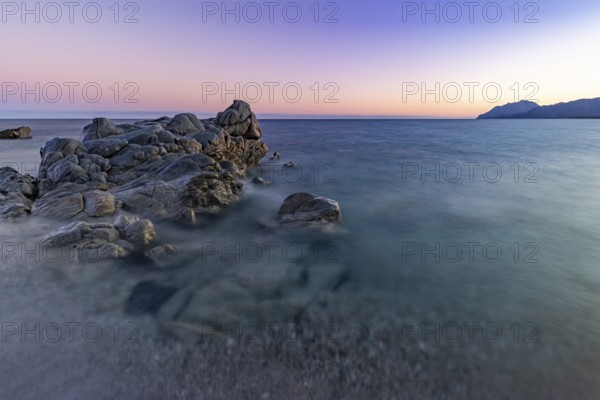 Rocks in the sea on the beach of Torre di Bari at sunset, long exposure, Torre di Bari, Bari Sardo, Ogliastra, Sardinia, Italy, Europe