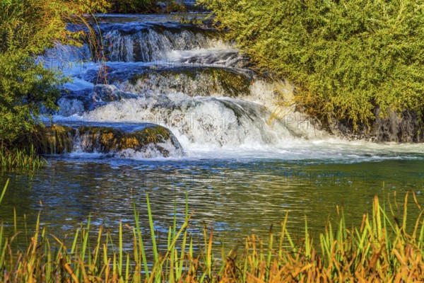 Croatia, Slunj. Little tourist town on the river Korana. Cascade waterfalls are lit by sunset rays. The concept of ecological, pedestrian and photo tourism, Europe