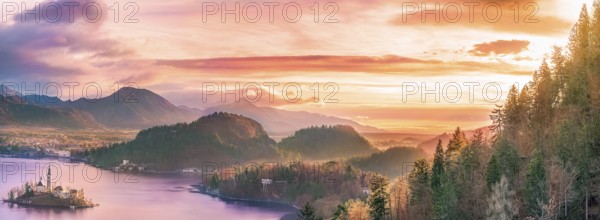 Panoramic view with the Bled island, the lake and the surrounding hills, in amazing colors due to the sunrise. Slovenia is a wonderful place to visit