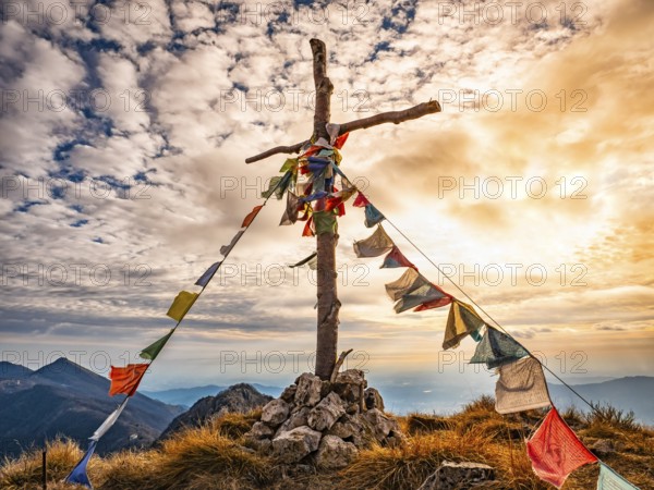 Wood cross on a mountain peak