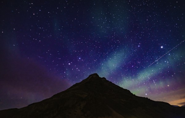 Of Iceland Aurora and mountain silhouette. Shooting Location: Iceland, Reykjavik