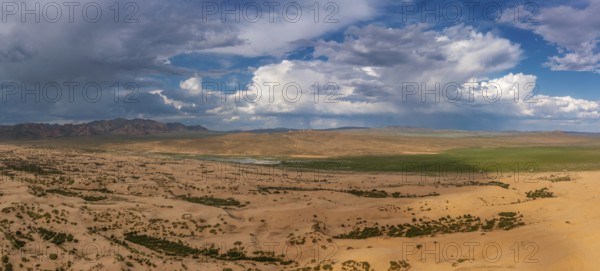 Aerial panorama view of the sand dunes Elsen Tasarhai (Bayan Gobi) desert and mountains in Mongolia