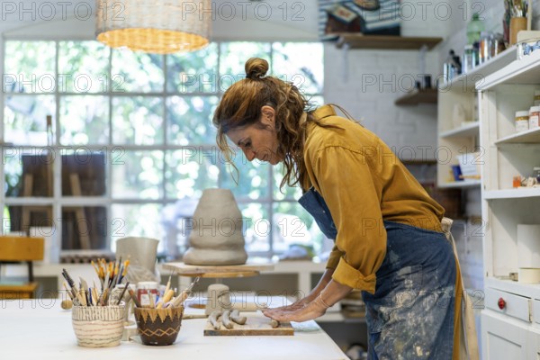 Woman artist crafting with clay and care