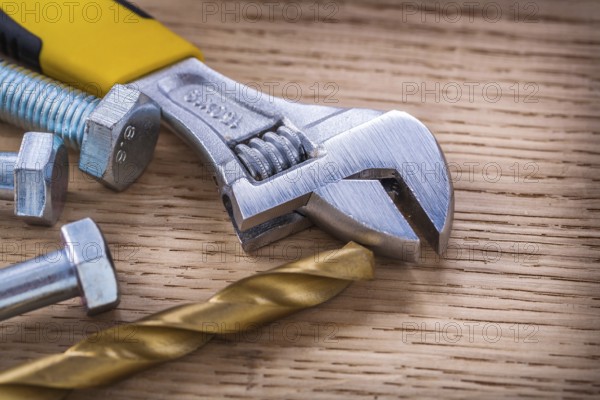 Composition screws adjustable wrench drill and bolt On Wooden Board