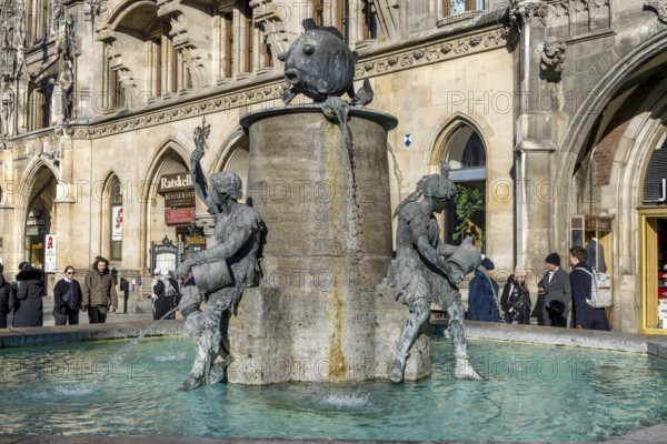 Fish fountain on Marienplatz in front of the New Town Hall in neo-Gothic style, Munich, Upper Bavaria, Bavaria, Germany, Europe