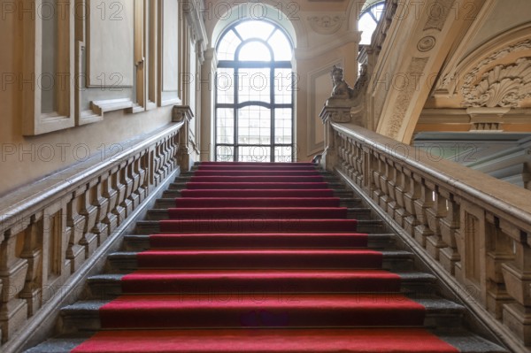 Turin, Italy, January 2023: Palazzo Barolo staircase. Luxury palace with old baroque interior and red carpet, Europe