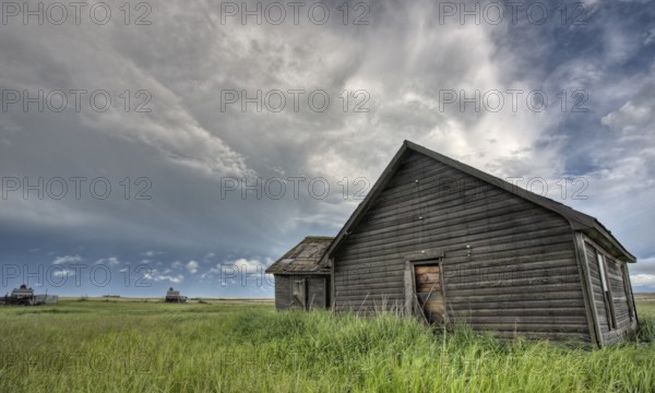 Abandoned Farm with storm clouds in the Canadian Prairie