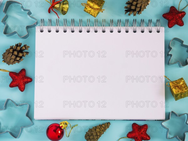 Christmas background with blank notebook, decorations. Copy space. Top view or flat lay. Toned image