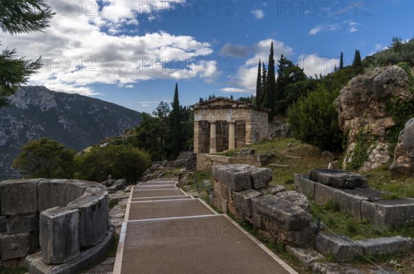 Delphi, Greece, 7 November, 2022: view of the Ahtenian Treasury in the Sanctuary Athena Pronaia in Delphi, Europe