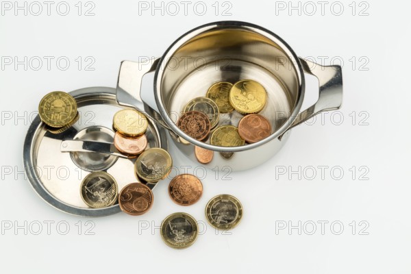 A cooking pot with a few euro coins, a symbolic photo of sovereign debt and the financial crisis in Austria