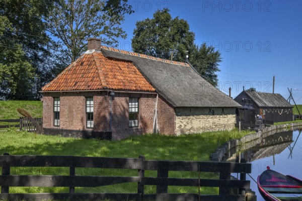 Enkhuizen, the Netherlands, September 2020. The Zuiderzeemuseum, an open air museum at the shore of the IJsselmeer with traditional Dutch fishermen cottages and flat bottomed fishing boats.