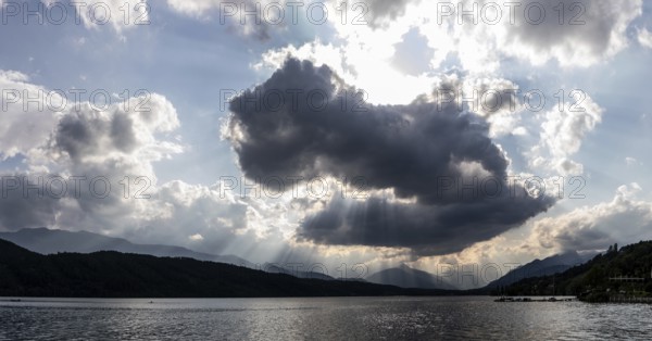 Cloudy mood over Lake Millstättersee, sunbeams from clouds, near Millstatt, Carinthia. Austria
