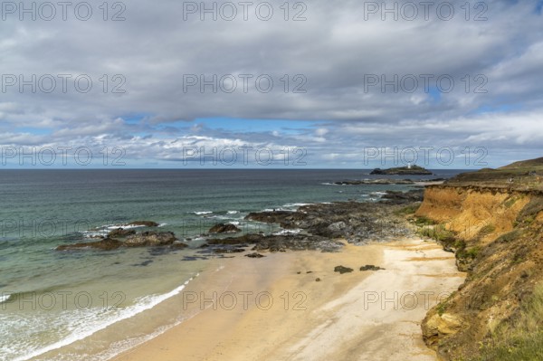 View of St. Ives Bay in Cornwall and small beach near Gwithian with the Godrevy Lighthouse in the background