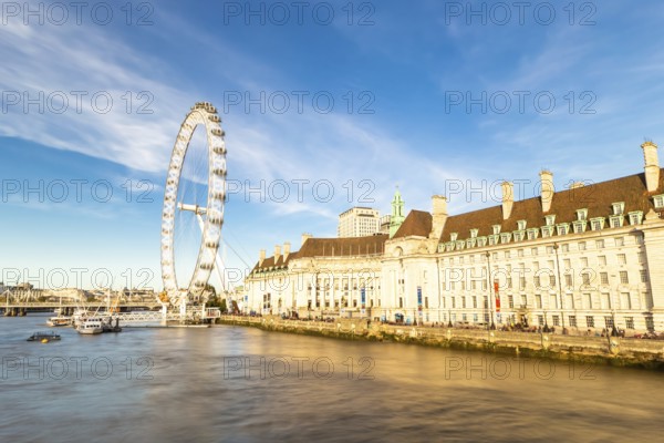 The London Eye on the South Bank of the River Thames at night in London, England. Europe