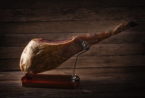Iberian ham pata negra from Spain on wood background