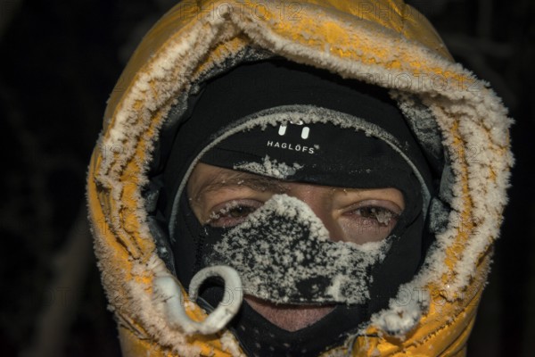 Man with frost-covered hood and balaclava, Abisko, Norrbotten, Lapland, Sweden, December 2012, Europe