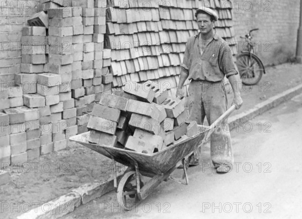 In the 1930s. A man with a wheelbarrow full of bricks. Sweden 1939