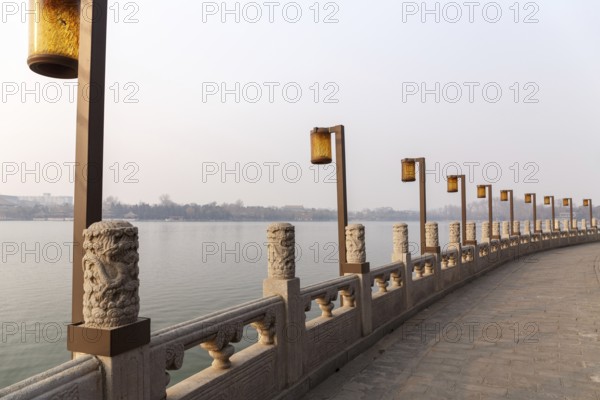 Lamps along a lakeside promenade in Beihai Park, Beijing, China in March 2018, Beijing, China, Asia