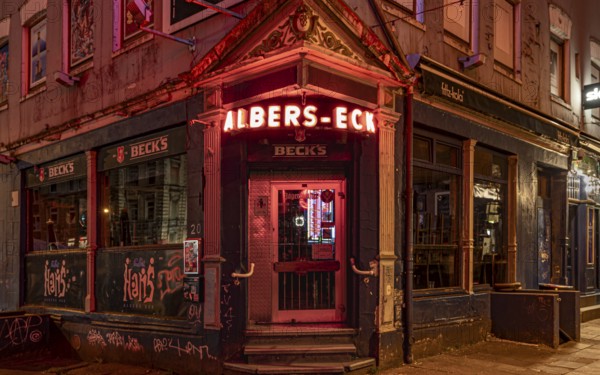 The façade of a traditional Hamburg pub with glowing red neon lights at night, Hans-Albers-Eck, St. Pauli, Free and Hanseatic City of Hamburg, Germany, Europe