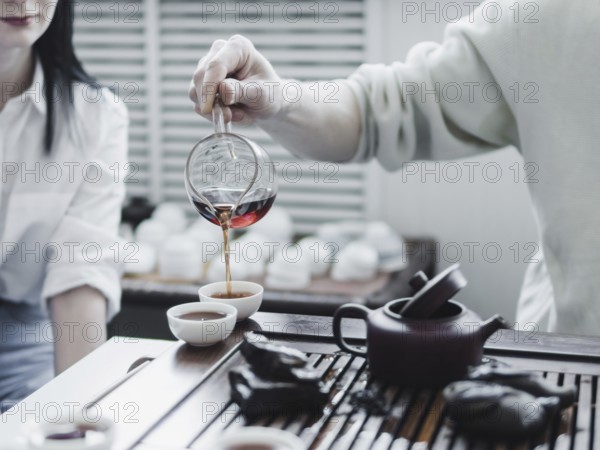 Chinese tea ceremony. Master pouring puer tea in cups. Pu erh tea ceremony