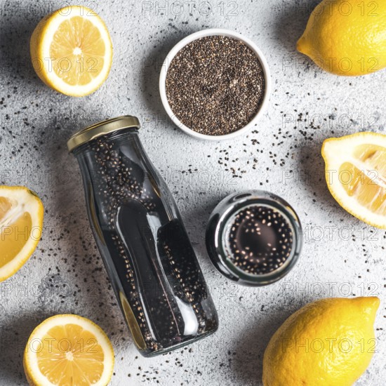 Detox activated charcoal black chia water or lemonade with lemon. Two bottle with black chia infused water. Detox drink idea and recipe. Vegan food and drink. Top view