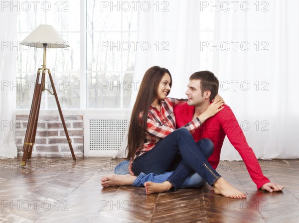 Couple in love at home relaxing on the floor