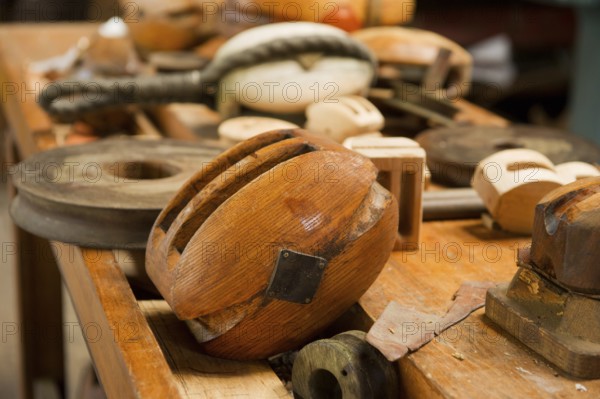 Old wooden pulleys laying at the table