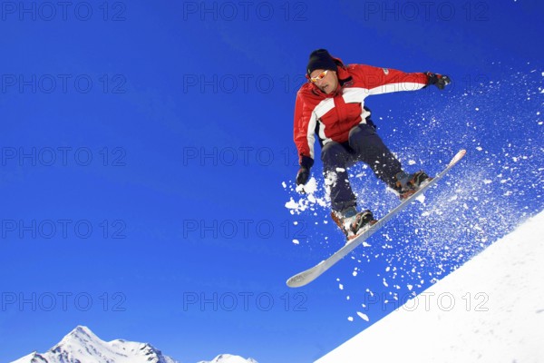 Skiers in action, descent on a slope, deep snow