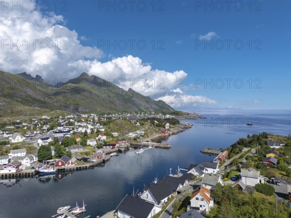 Village scene amidst lush landscape, in the background view of the Vestfjord, Sorvagen, Lofoten, Norway, Europe