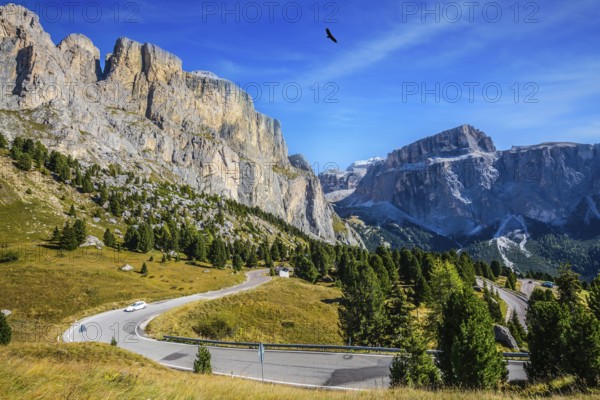Picturesque road through the Sella Pass, Dolomites. The concept of extreme and ecological tourism. Impressive ridge of dolomite rocks. Indian summer in the Tyrol
