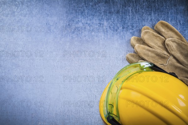 Collection of protective workwear on scratched metallic background top view construction concept