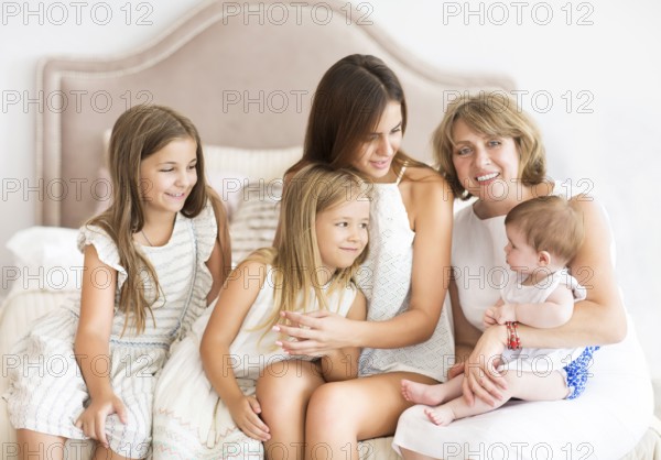 Mature woman embrace with little girl. Grandmother and granddaughters. Family and love concept