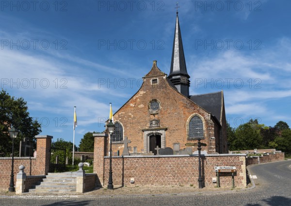 Lennik, Flemish Brabant Region, Belgium, 07 20 2021 Exterior of a traditional brick stone catholic church, Europe