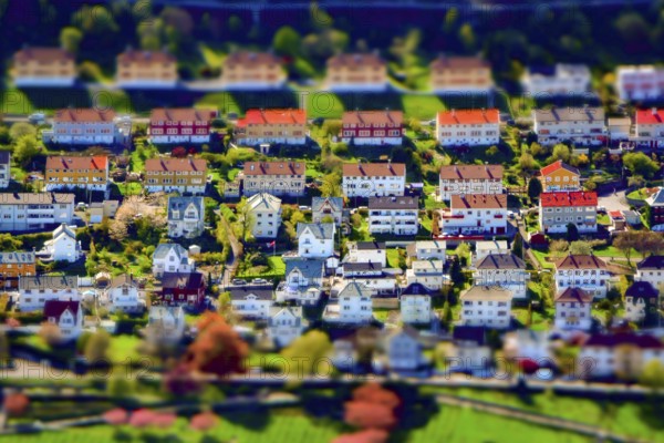 Tilt-shift creative image of an upper-class residential city suburb district with houses and gardens. Miniature effect
