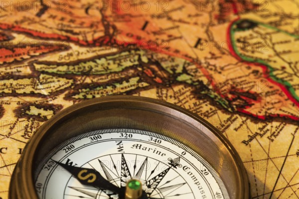 An old compass lies on a map of Austria