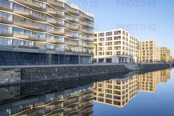 Modern apartment blocks in Berlin with a reflection in a small canal