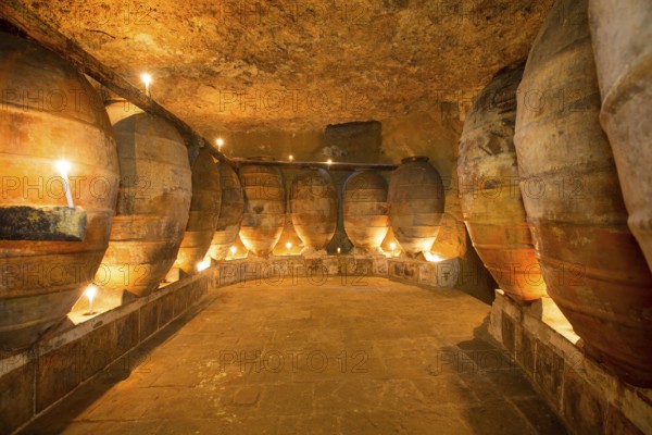 Antique winery in Spain with clay vessels terracotta amphora pots Mediterranean tradition with candlelight
