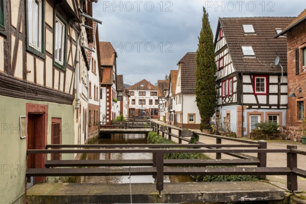 Half-timbered houses on Gerbergasse by the River Queich in the old town centre of Annweiler am Trifels, Rhineland-Palatinate, Germany, Europe