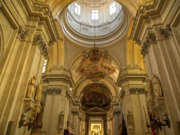 Impressive interior view of a baroque church with high columns and ornate frescoes on the ceiling, montserrat, spain
