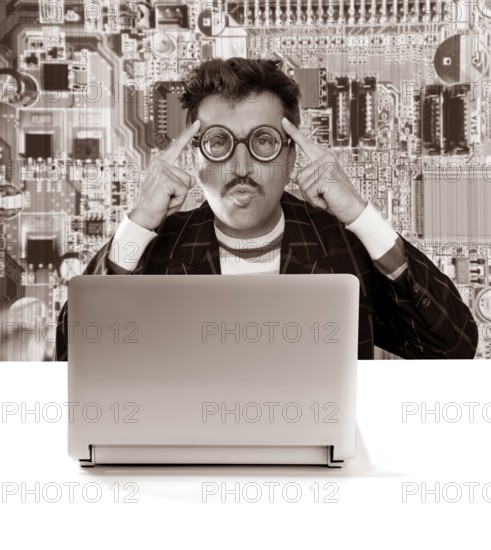 Nerd pensive man with myopic glasses looking for solution on electronics technology problem