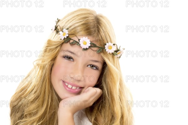 Children blond girl with spring daisy flowers crown smiling on white