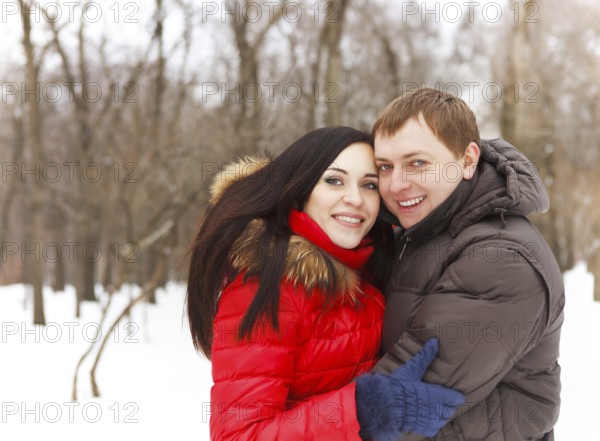 Happy young couple having fun in the winter park