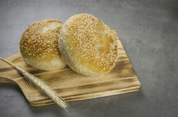 Beautiful Sourdough bread on gray background with dried wheat flower