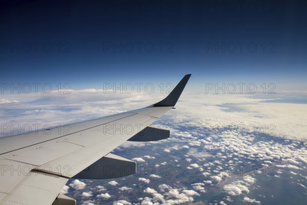 Wings of an aeroplane above the clouds