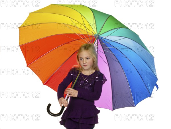 A small child with a colourful umbrella in front of a white background. Austria