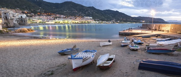 Panorama night shot of beautiful bay and fishing boats in Cefalu, Sicily, Italy, Europe