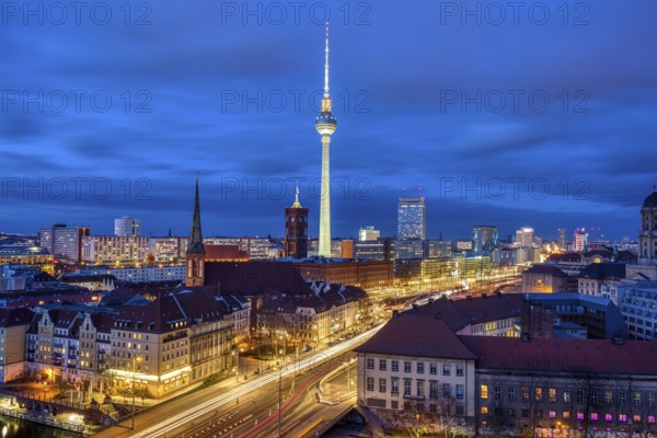 The centre of Berlin with the famous television tower and a cloudy sky at night