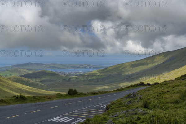 The steep and winding mountain road leading to the top of Connor Pass on the Dingle Peninsula