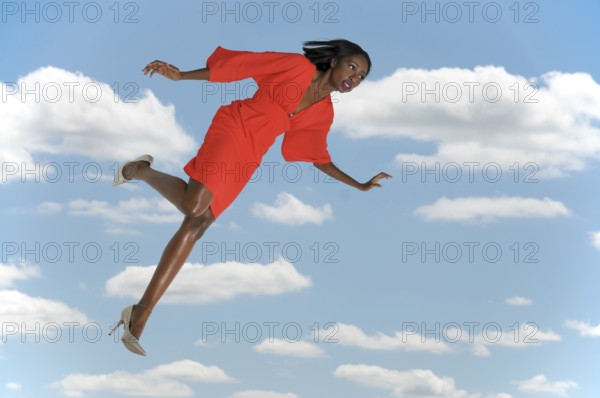 Beautiful young woman falling through the sky